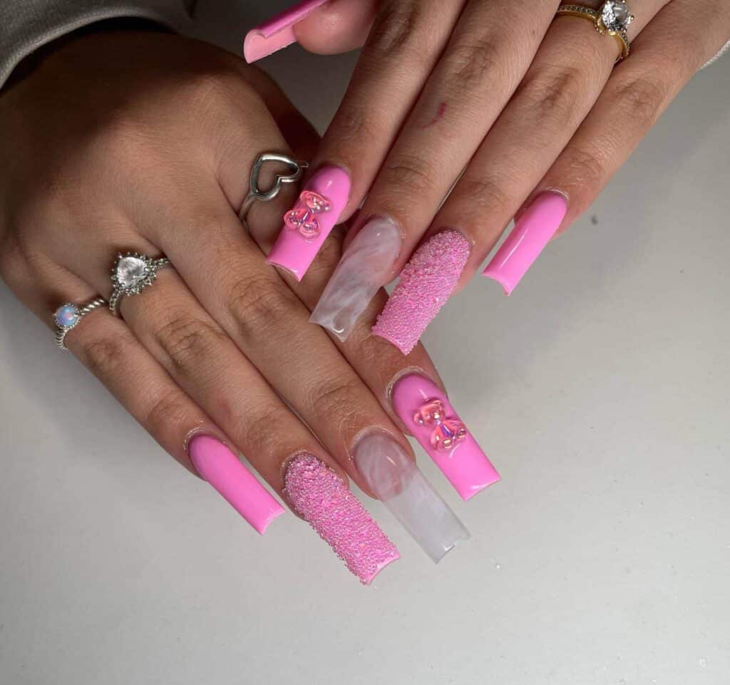 Explore a variety of pink nail designs, from bright and cute styles to festive Christmas nails with intricate patterns and decorations.