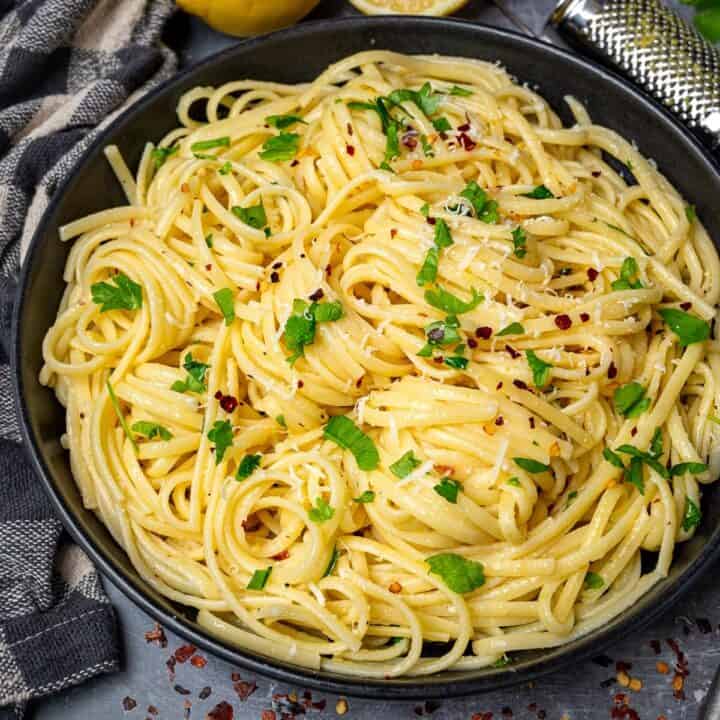 A vibrant array of freshly prepared pasta recipes, including spaghetti, penne, and fusilli, adorned with various sauces, herbs, and garnishes