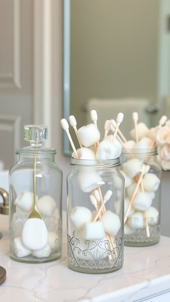 Glass jars filled with cotton balls and swabs on a bathroom countertop.