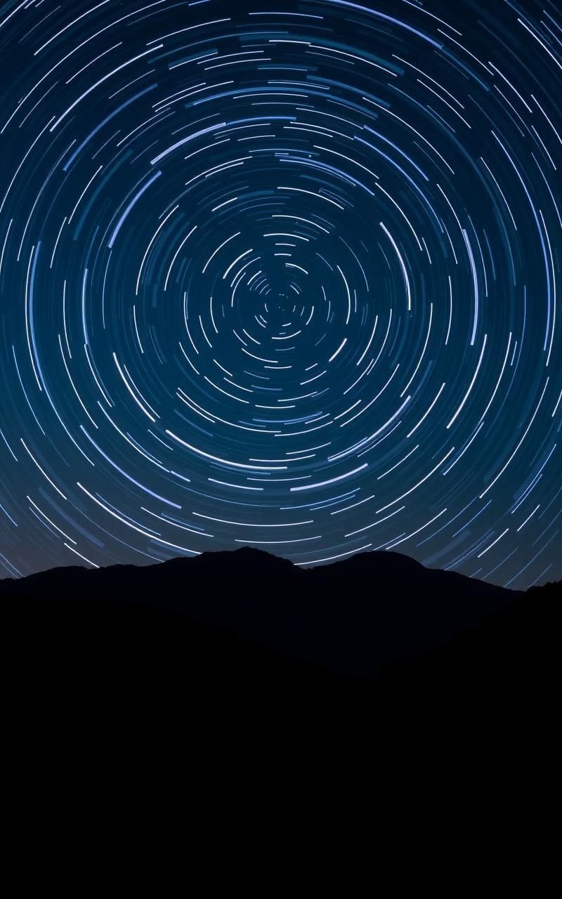 Star Trails Over Mountain Silhouettes