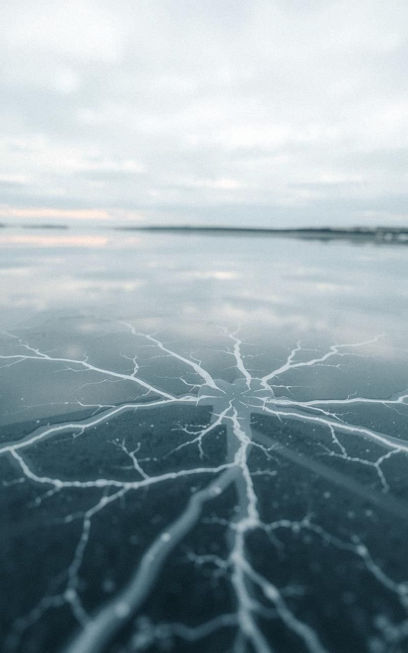 Frozen Lake with Ice Cracks and Reflections