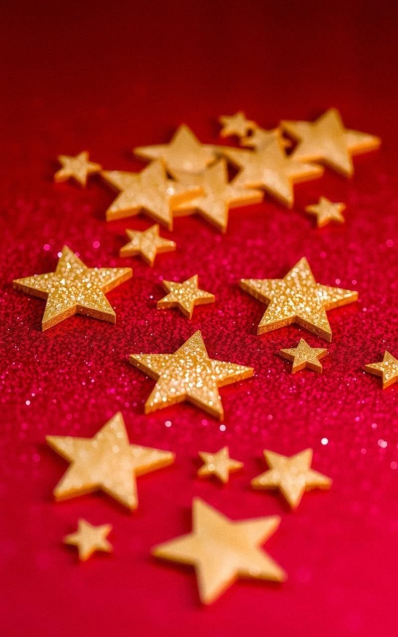 Shimmering Gold Stars on Festive Red Background