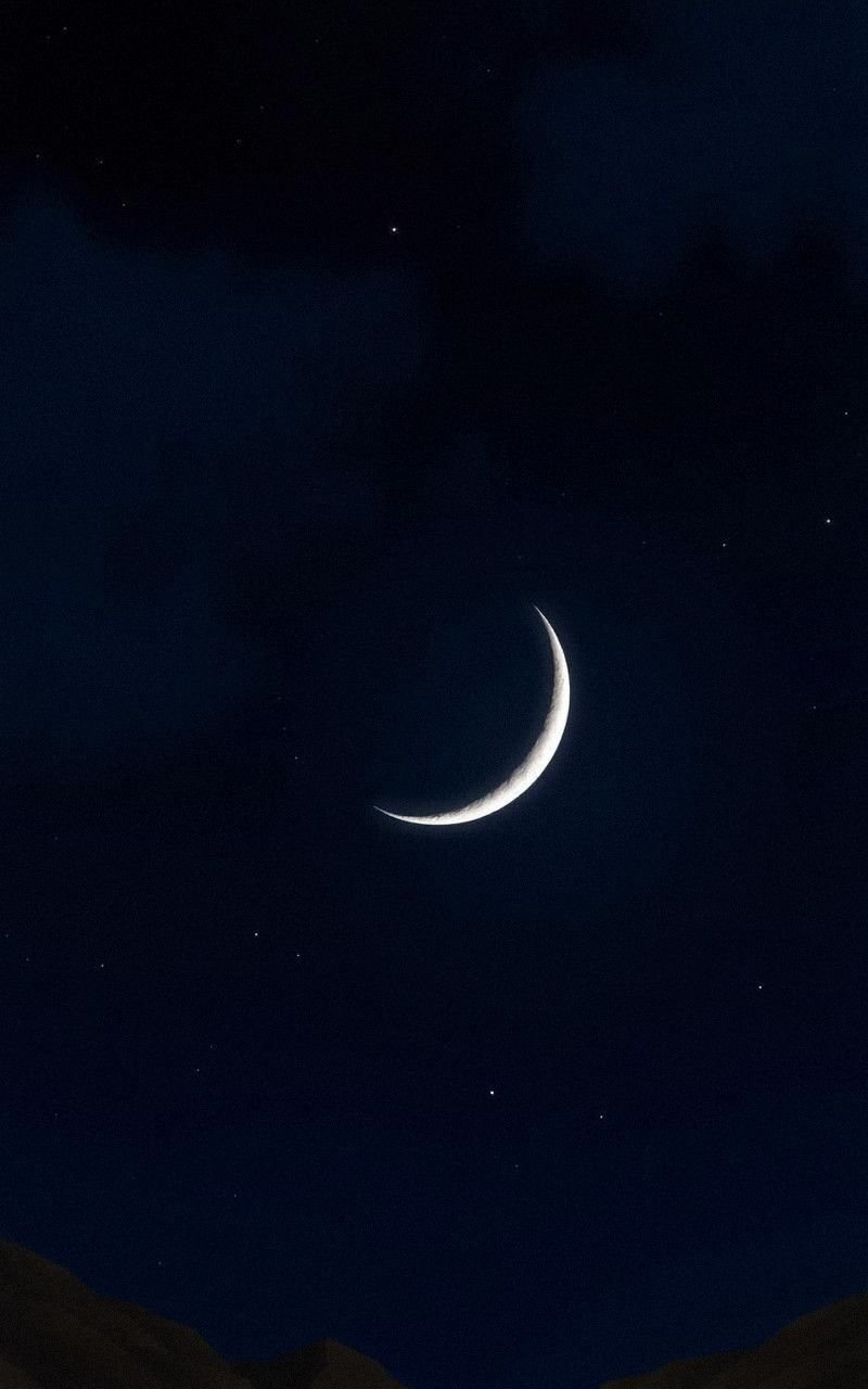 Ethereal Crescent Moon Against Starry Night