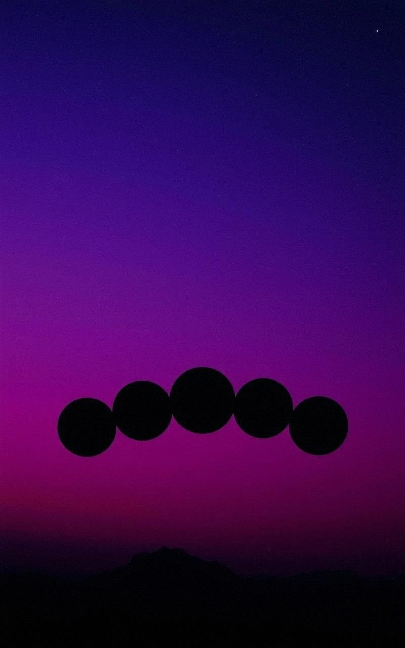 Shadowed Moon Phases Against Deep Purple Sky