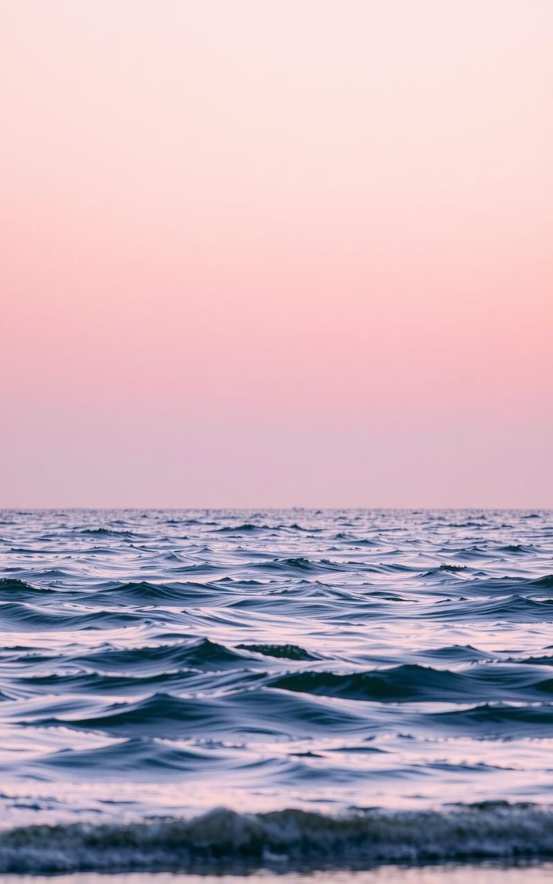 Soft Pink Sky Over Gentle Ocean Waves