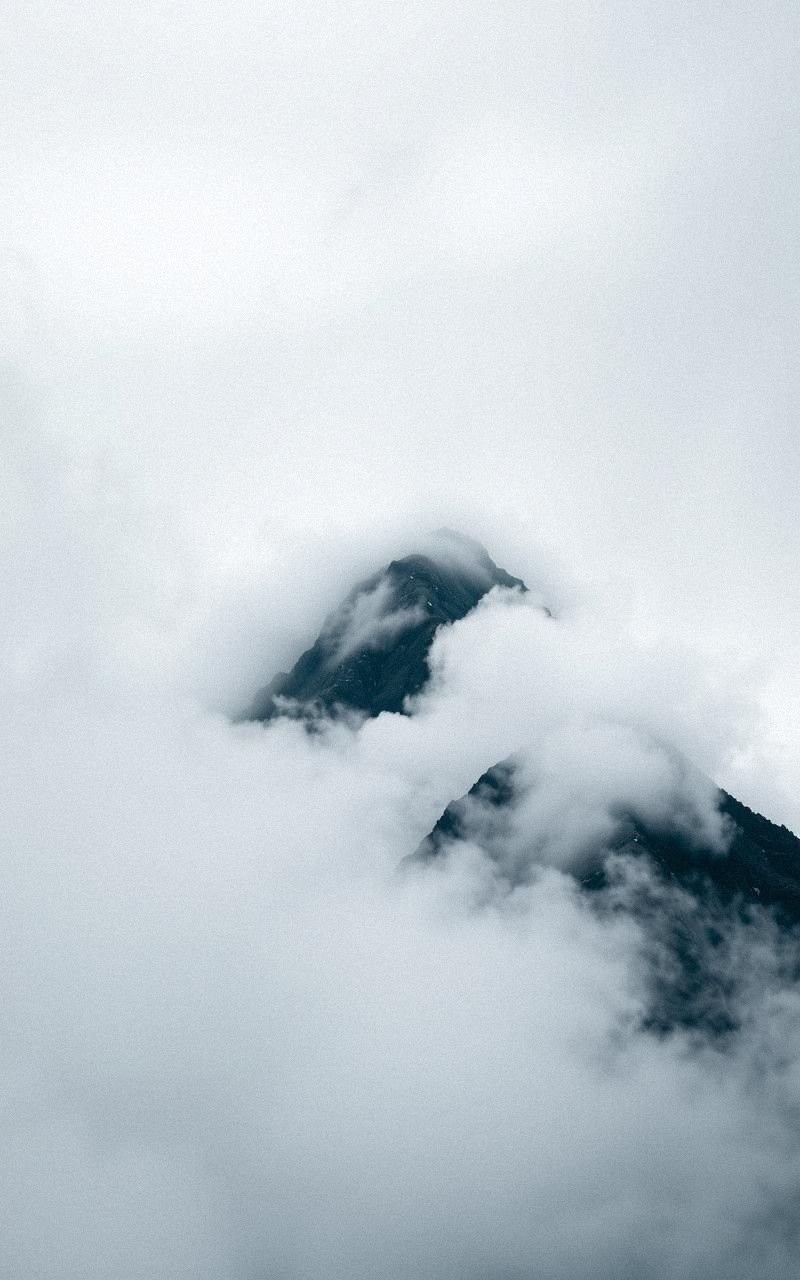 Clouds Rolling Over High Mountain Summit