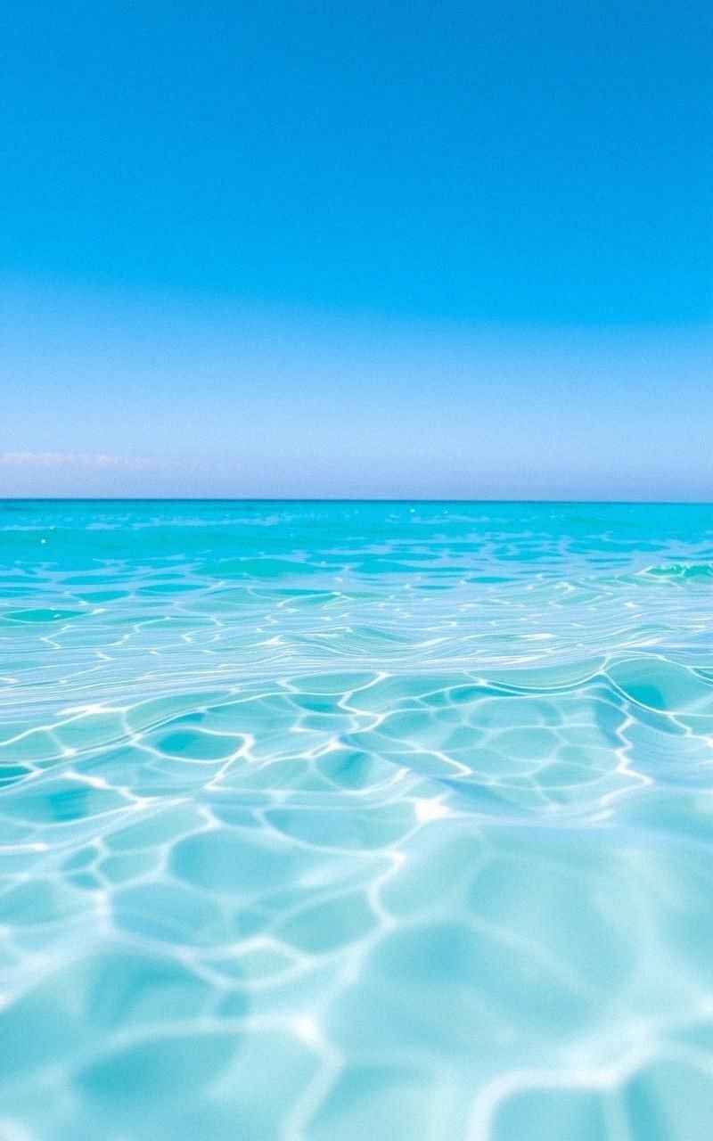 Bright Aqua Waves Under Clear Sunny Sky