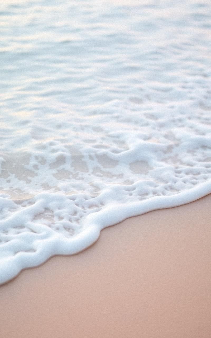 Soft Pastel Waves Lapping a Quiet Beach