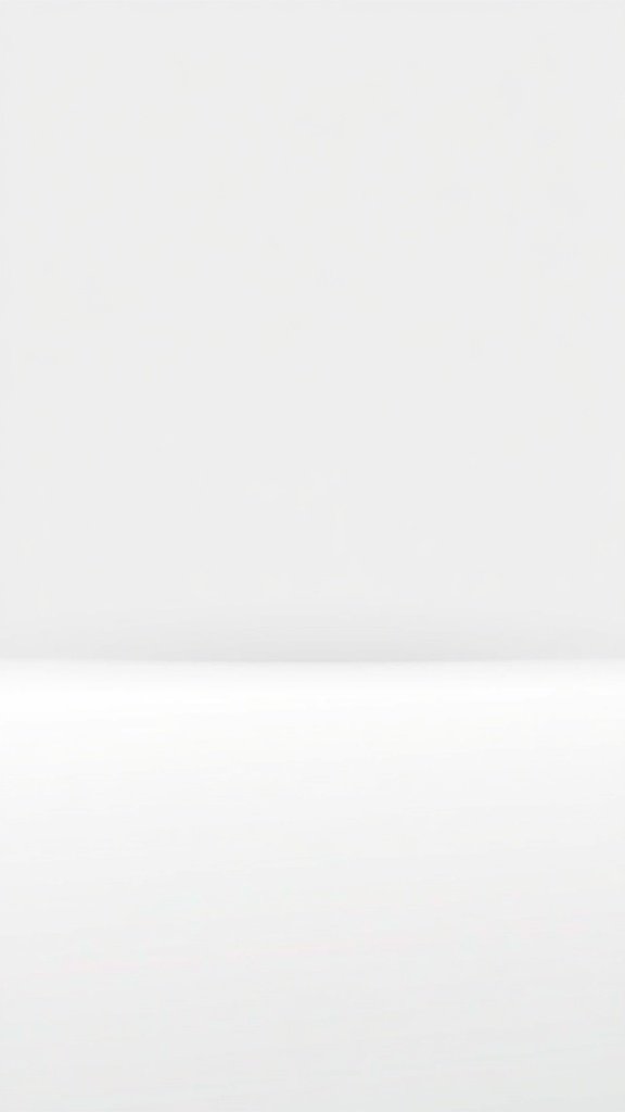 A minimalist monochrome wallpaper featuring a smooth gradient from white to light gray.