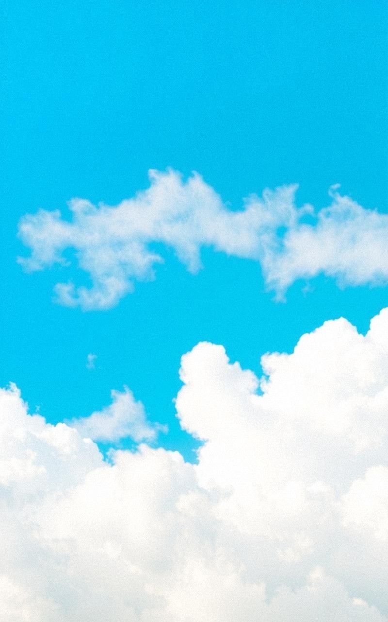 Bright Cerulean Sky With Fluffy White Clouds