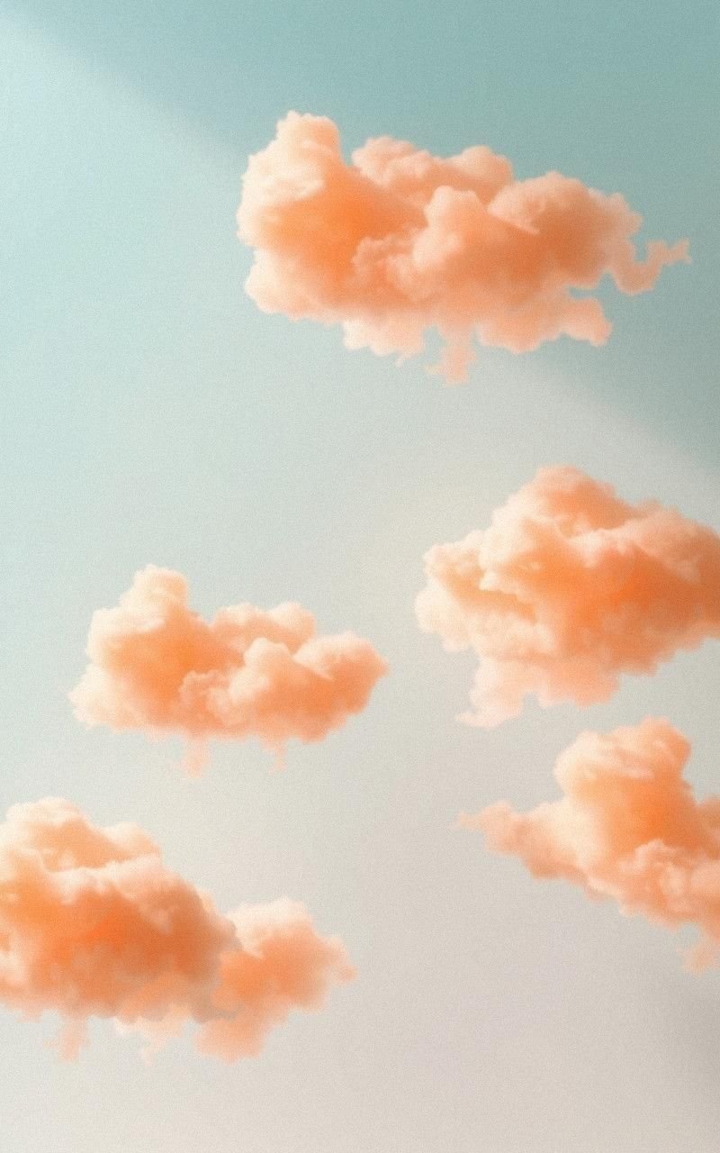Sun-Kissed Clouds Against Light Blue Canvas