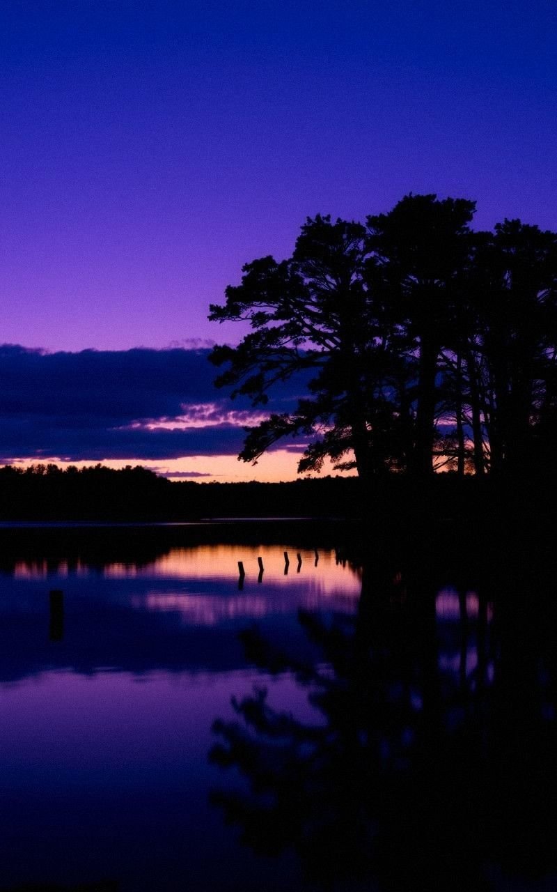 Calm Lake at Twilight with Purple Sky Reflection